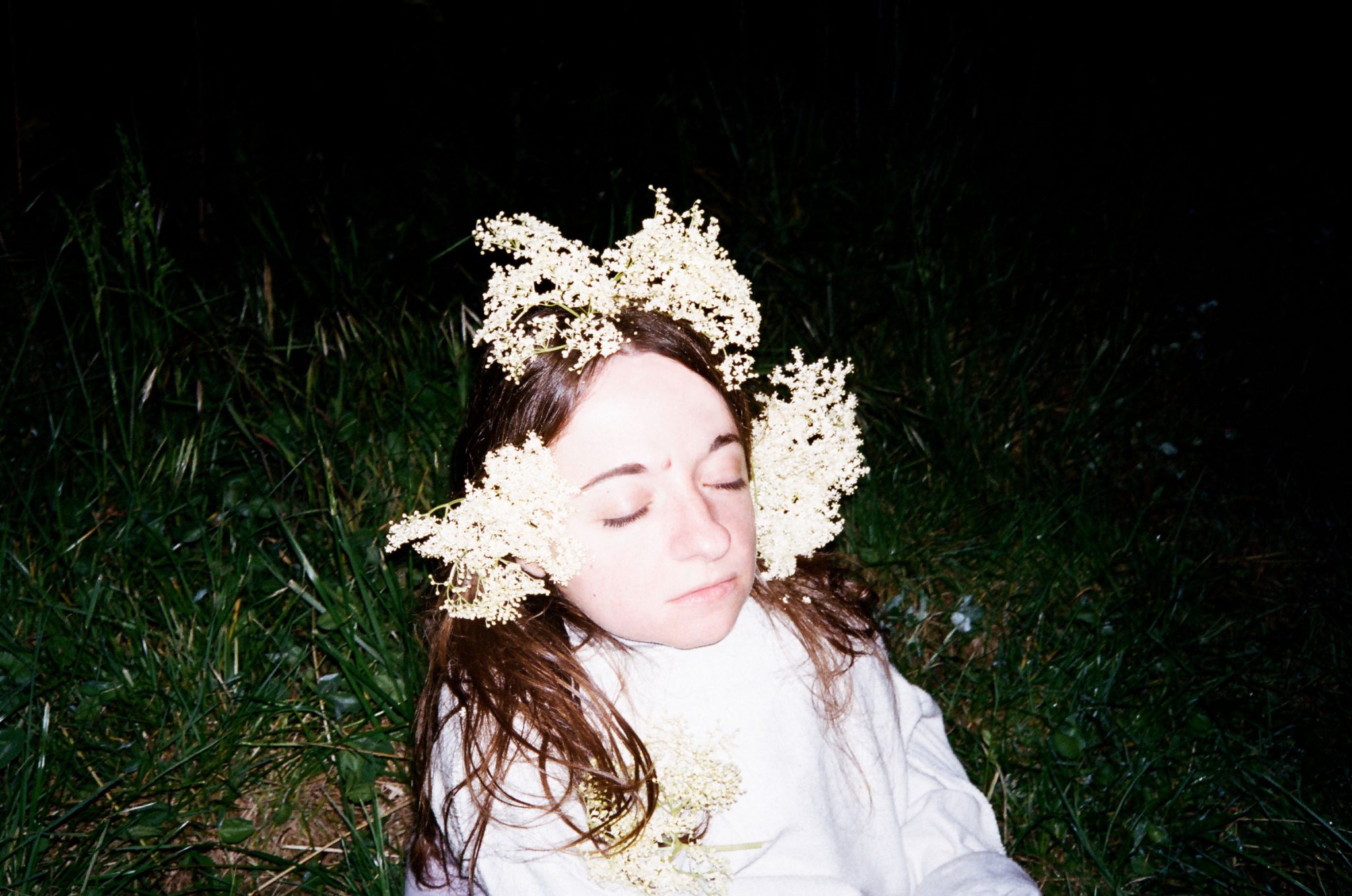 Artist Chiara Bersani outside with flowers around her head