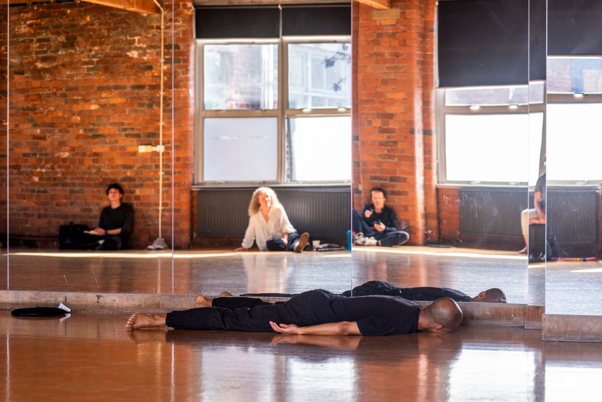 Tiran Willemse lies on the floor in a dance studio
